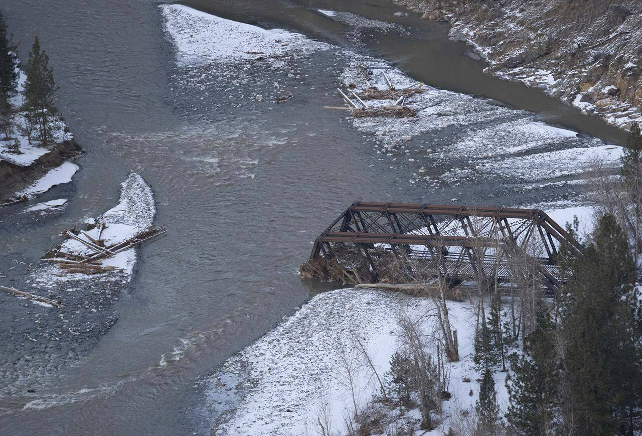 A rail bridge washed out from the flood waters is pictured near Merritt, B.C. Thursday, Dec. 9, 2021. Economic growth in British Columbia will face erosion from the recent floods and slides that crippled transportation links, but the resilience of government and industry to keep supply chains open limits the damage, says an economist. THE CANADIAN PRESS/Jonathan Hayward