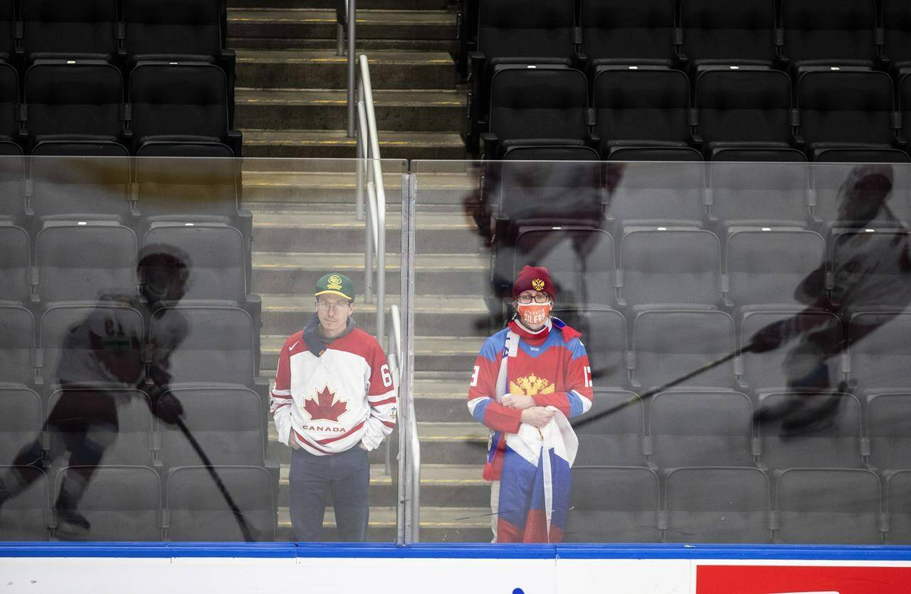 Fans watch as Canada and Russia warm up before first period IIHF World Junior Hockey Championship exhibition action in Edmonton, Thursday, Dec. 23, 2021. Alberta is about to host a third pandemic International Ice Hockey Federation tournament armed with experience from the first two, but with the ice still shifting underfoot. THE CANADIAN PRESS/Jason Franson