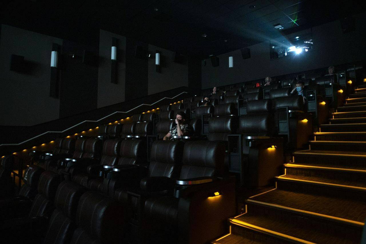Moviegoers sit in a theatre at a Cineplex in Toronto, Tuesday, Oct. 6, 2020. Canadians hoping to continue their long tradition of heading to the movies on Christmas Day will have to mask up and check their local restrictions. THE CANADIAN PRESS/Chris Young