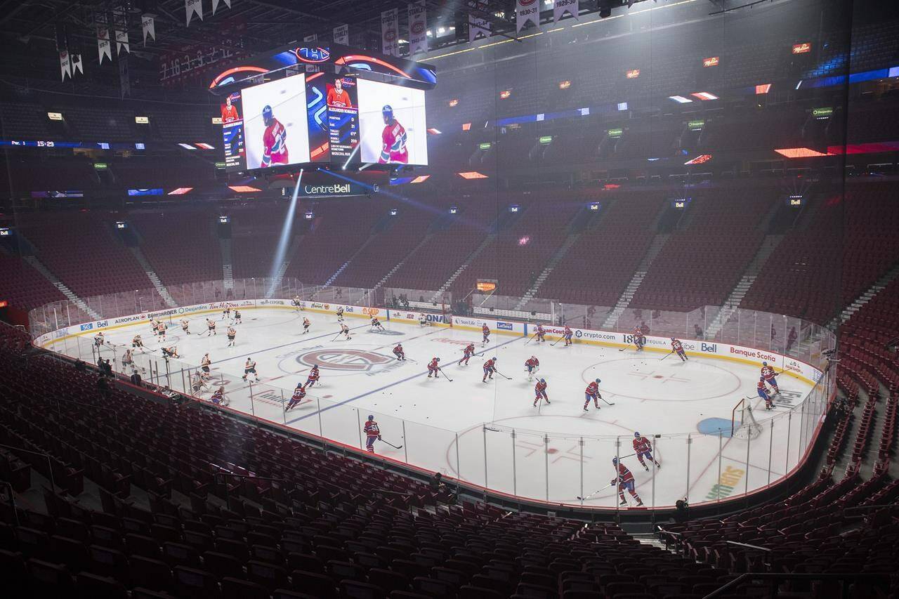 Players from the Montreal Canadiens and the Philadelphia Flyers skate before an empty arena prior to an NHL game in Montreal, Thursday, December 16, 2021. The NHL has postponed five home games for the Montreal Canadiens due to measures related to the COVID-19 pandemic. THE CANADIAN PRESS/Graham Hughes