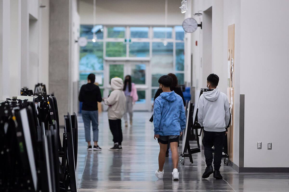 Students walk through a corridor at the relocated New Westminster Secondary School, in New Westminster, B.C., on Thursday, October 14, 2021. THE CANADIAN PRESS/Darryl Dyck