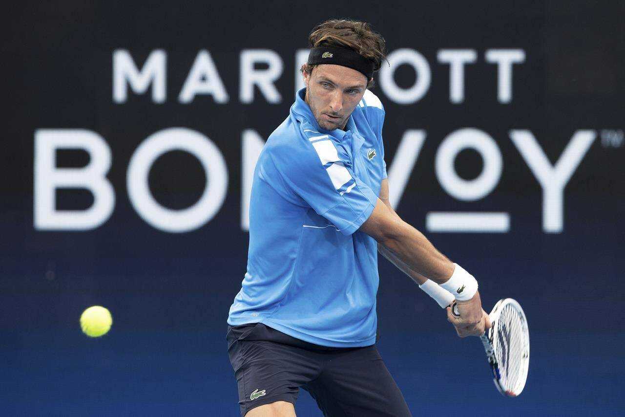 Arthur Rinderknech of France plays a shot against Russia’s Roman Safiullin during their match at the ATP Cup tennis tournament in Sydney, Sunday, Jan. 2, 2022. (AP Photo/Steve Christo)