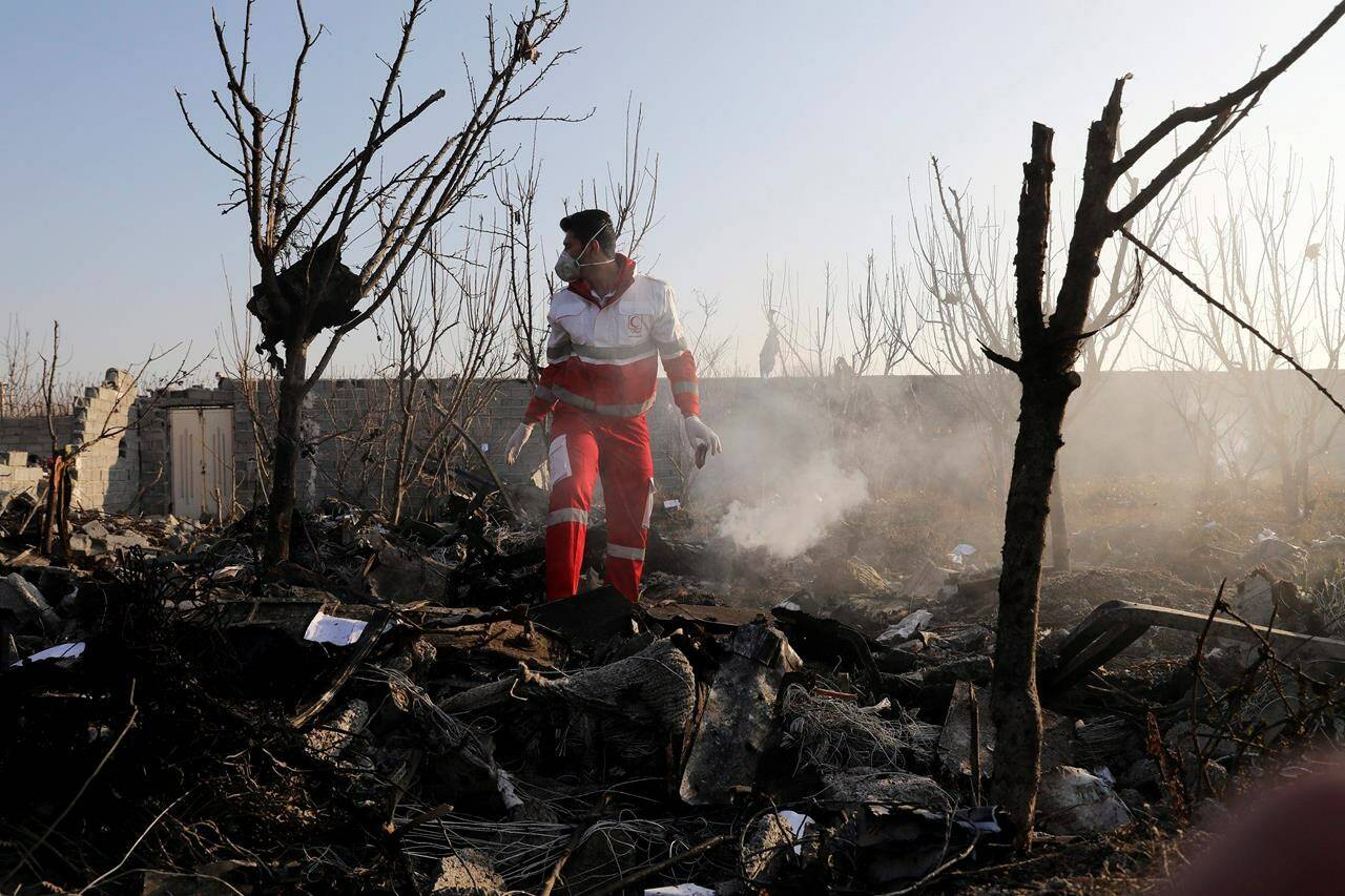 A rescue worker searches the scene where an Ukrainian plane crashed in Shahedshahr, southwest of the capital Tehran, Iran, Wednesday, Jan. 8, 2020. The family members of some of the victims of the Iranian military’s downing of a passenger jet two years ago, along with their legal team, are set to discuss a court decision that awarded millions to them in a news conference Tuesday. THE CANADIAN PRESS/AP-Ebrahim Noroozi