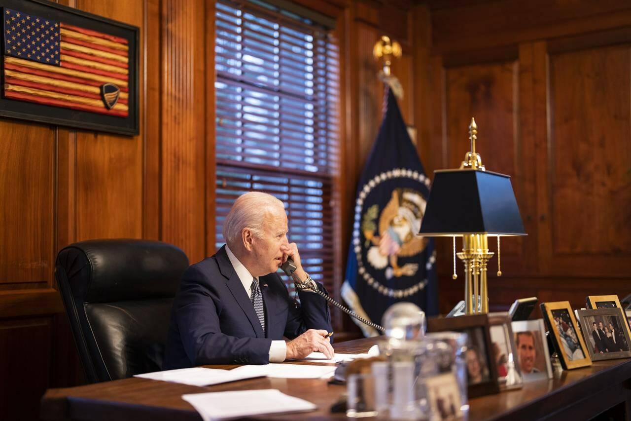 In this image provided by The White House, President Joe Biden speaks with Russian President Vladimir Putin on the phone from his private residence in Wilmington, Del., Thursday, Dec. 30, 2021. The Biden administration and its European allies are beginning a series of meetings aimed at showing Russia that an invasion of Ukraine would be met with a forceful response.(Adam Schultz/The White House via AP)