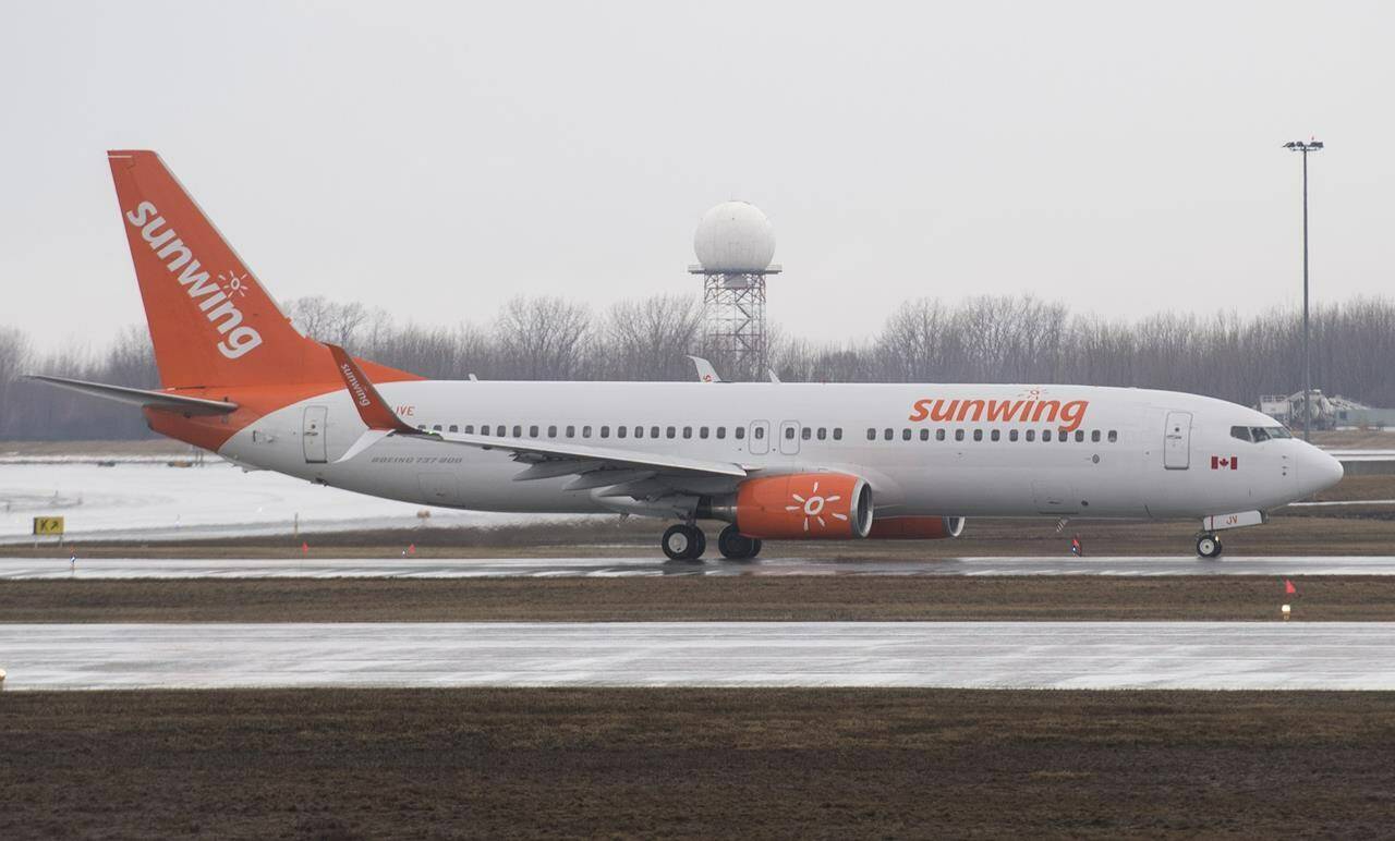 A Sunwing Airlines jet prepares to take off at Montreal’s Trudeau International Airport, Friday, March 20, 2020. Experts say the Sunwing party flight might have been halted mid-trip had certain aviation protocols been strictly followed. THE CANADIAN PRESS/Graham Hughes