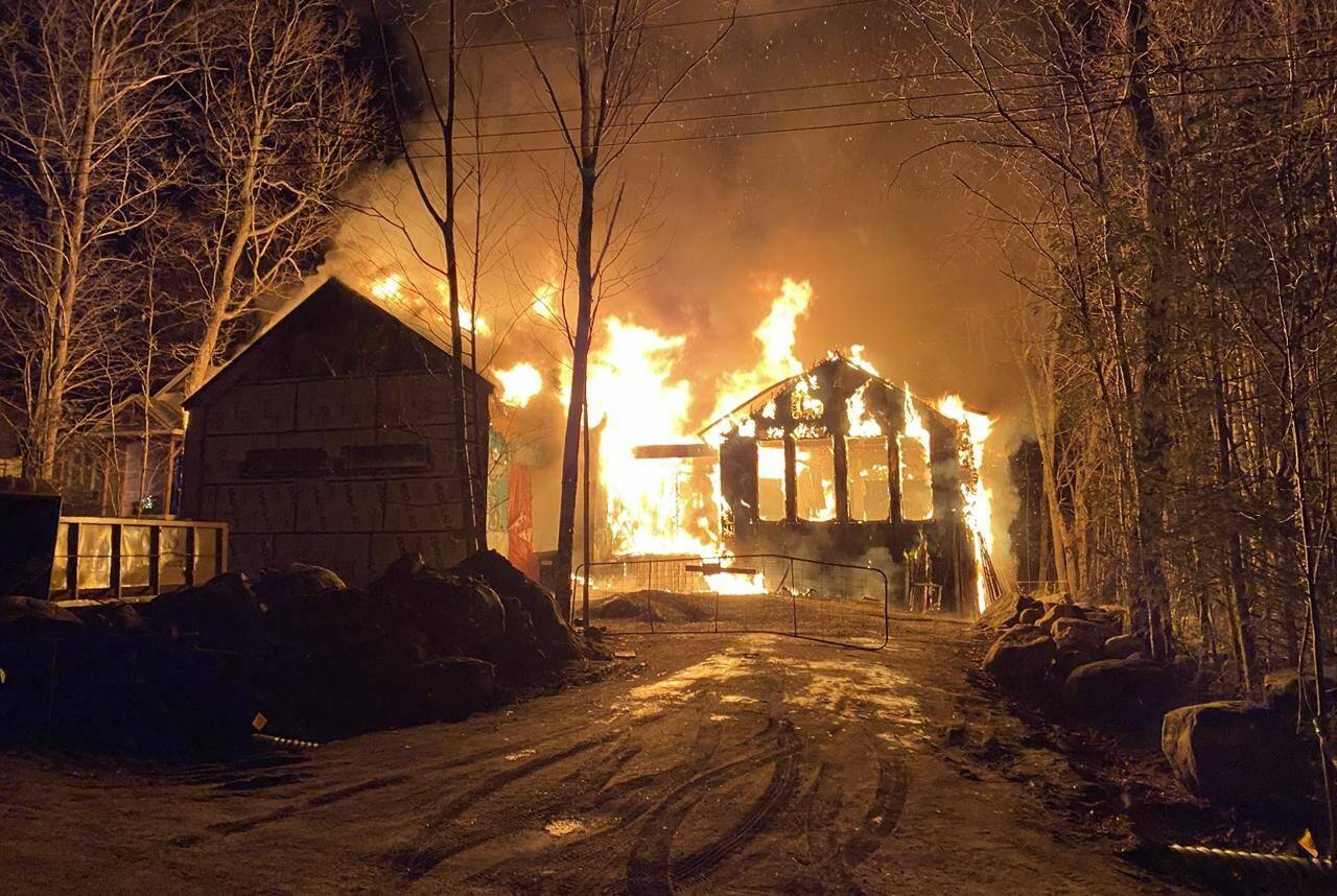 Paul Stanczak and Danielle Bablich’s cottage, which was still under construction, is seen on fire in a suspected case of arson which left the structure, near Ontario’s Georgian Bay, in ashes on Boxing Day, in a Dec. 26, 2021, handout photo. THE CANADIAN PRESS/HO-Danielle Bablich, *MANDATORY CREDIT*