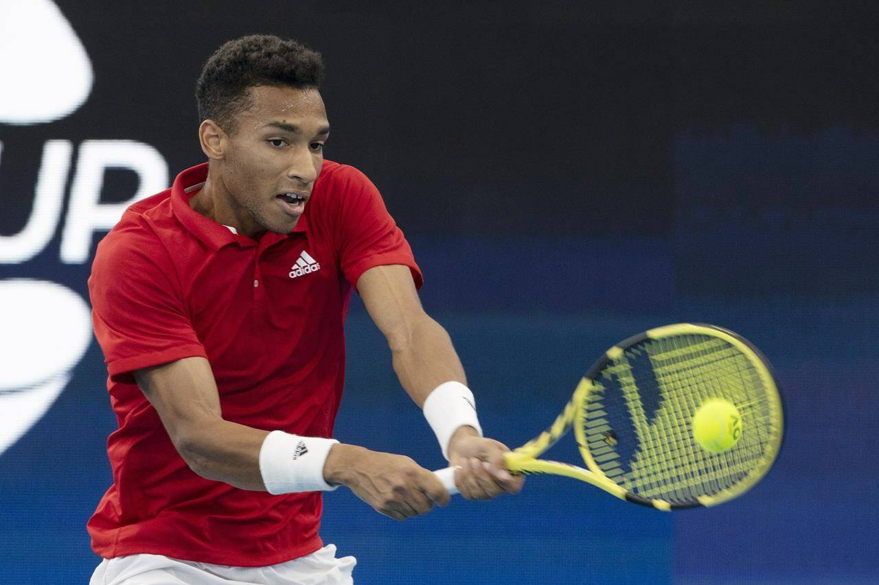 Felix Auger-Aliassime of Canada plays a shot against Russia’s Daniil Medvedev during their semifinal match at the ATP Cup tennis tournament in Sydney, Saturday, Jan. 8, 2022. (AP Photo/Steve Christo)