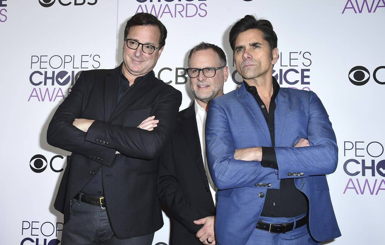 FILE - Bob Saget, from left, Dave Coulier and John Stamos, winners of the award for favorite premium comedy series for “Fuller House,” pose in the press room at the People’s Choice Awards at the Microsoft Theater on Wednesday, Jan. 18, 2017, in Los Angeles. Saget, a comedian and actor known for his role as a widower raising a trio of daughters in the sitcom “Full House,” has died, according to authorities in Florida, Sunday, Jan. 9, 2022. He was 65. (Photo by Jordan Strauss/Invision/AP, File)