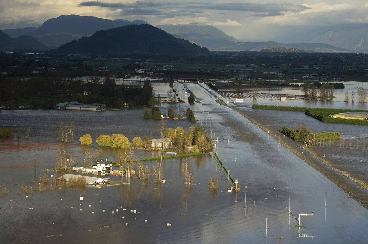 Rising floodwater surrounds a home and covers Highway 1 in Abbotsford,  B.C., Tuesday, Nov. 16, 2021. THE CANADIAN PRESS/Jonathan Hayward