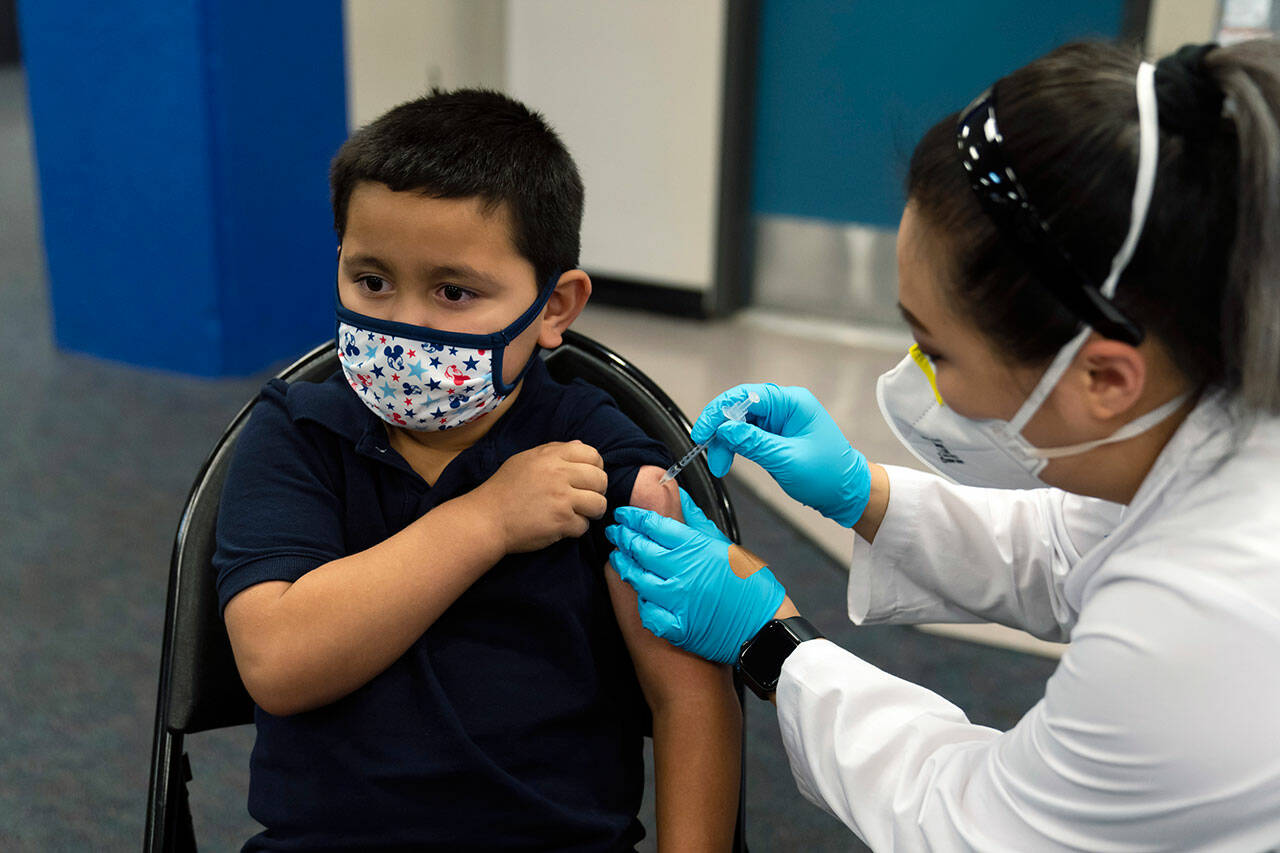 Eric Aviles, age 6, receives the Pfizer COVID-19 vaccine from pharmacist Sylvia Uong at a vaccine clinic for children ages 5 to 11 in Santa Ana, Calif., Nov. 9, 2021. Vaccines for children are being administered at community clinics in B.C.(Associated Press/Jae C. Hong)