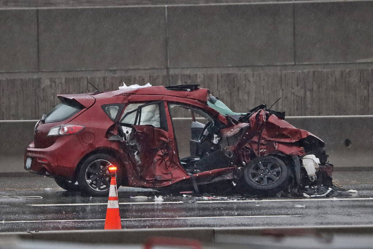 The occupants of a red Mazda3 were taken to hospital with critical injuries after Mounties believe they crashed into a dump truck on Highway 1, near the Port Mann Bridge, in Coquitlam. (Shane MacKichan)