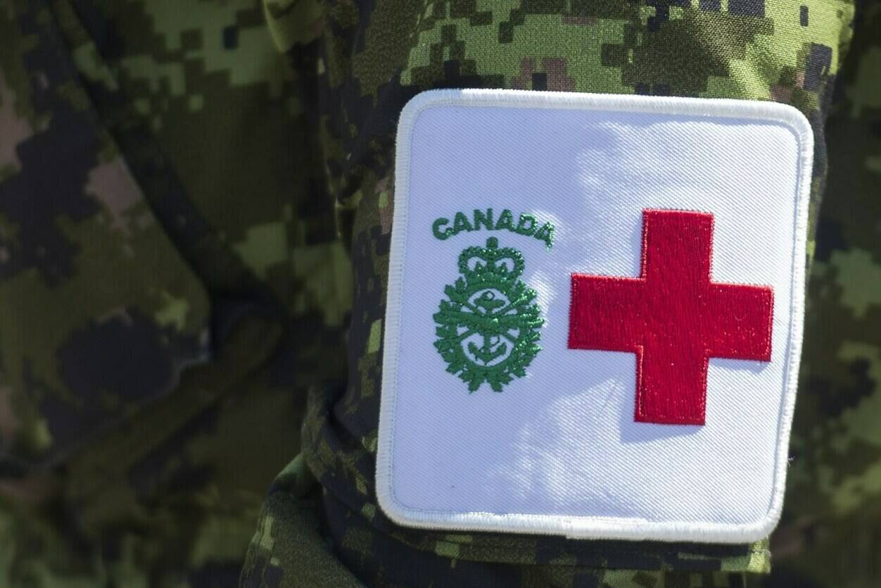 A patch is seen on a member of the Canadian Armed Forces at Residence Yvon-Brunet, a long-term care home in Montreal, on Saturday, April 18, 2020. The Canadian Armed Forces says its medical personnel have been stretched to the limit during the pandemic, suggesting it can offer little help to provincial health care systems overwhelmed by the Omicron variant of COVID-19. THE CANADIAN PRESS/Graham Hughes