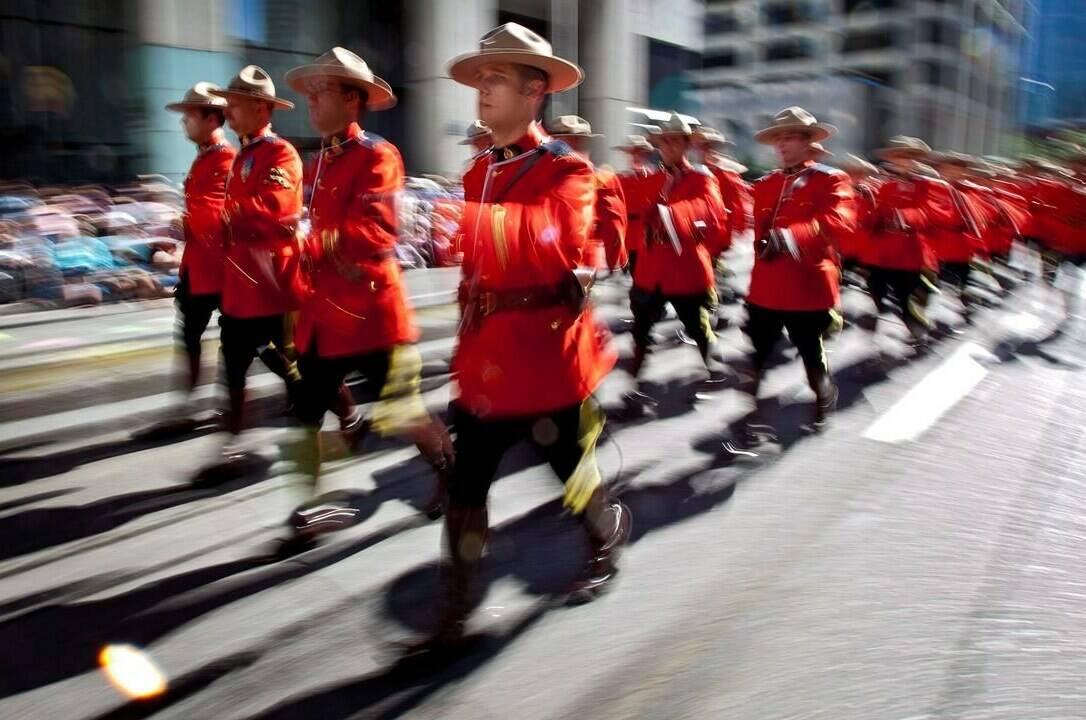 Members of the RCMP march during the Calgary Stampede parade in Calgary, Friday, July 6, 2012.THE CANADIAN PRESS/Jeff McIntosh