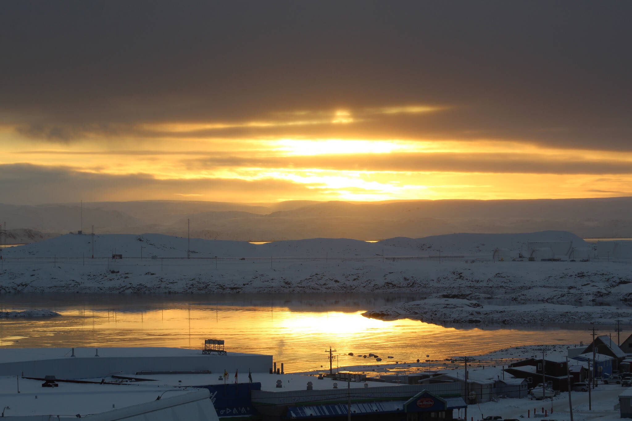 The sun sets over Iqaluit, Nunavut, on Monday, Oct. 26, 2020. THE CANADIAN PRESS/Emma Tranter