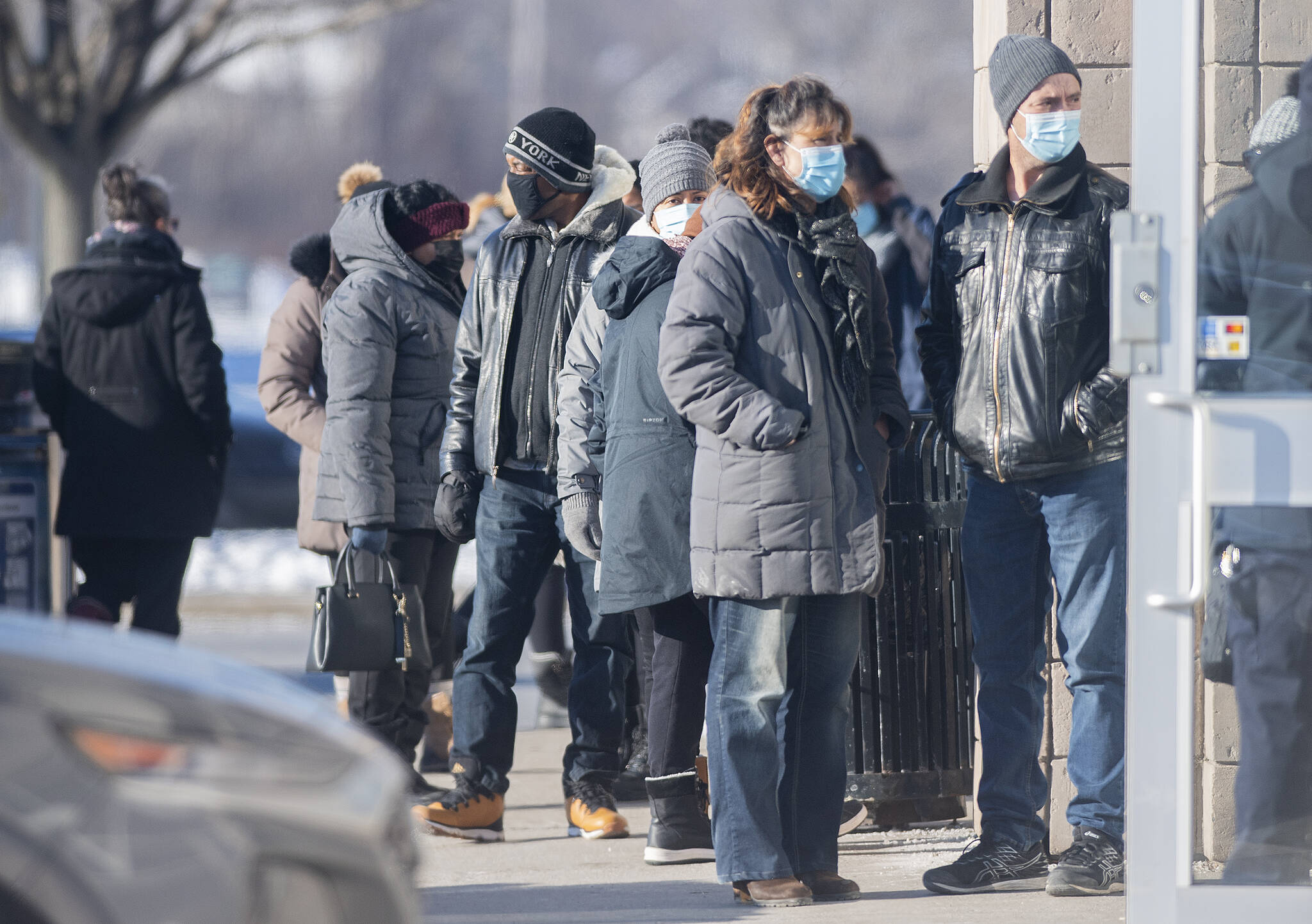 People line up to receive a COVID-19 test in Kirkland, west of Montreal, Friday, December 24, 2021, as the COVID-19 pandemic continues in Canada and around the world. THE CANADIAN PRESS/Graham Hughes