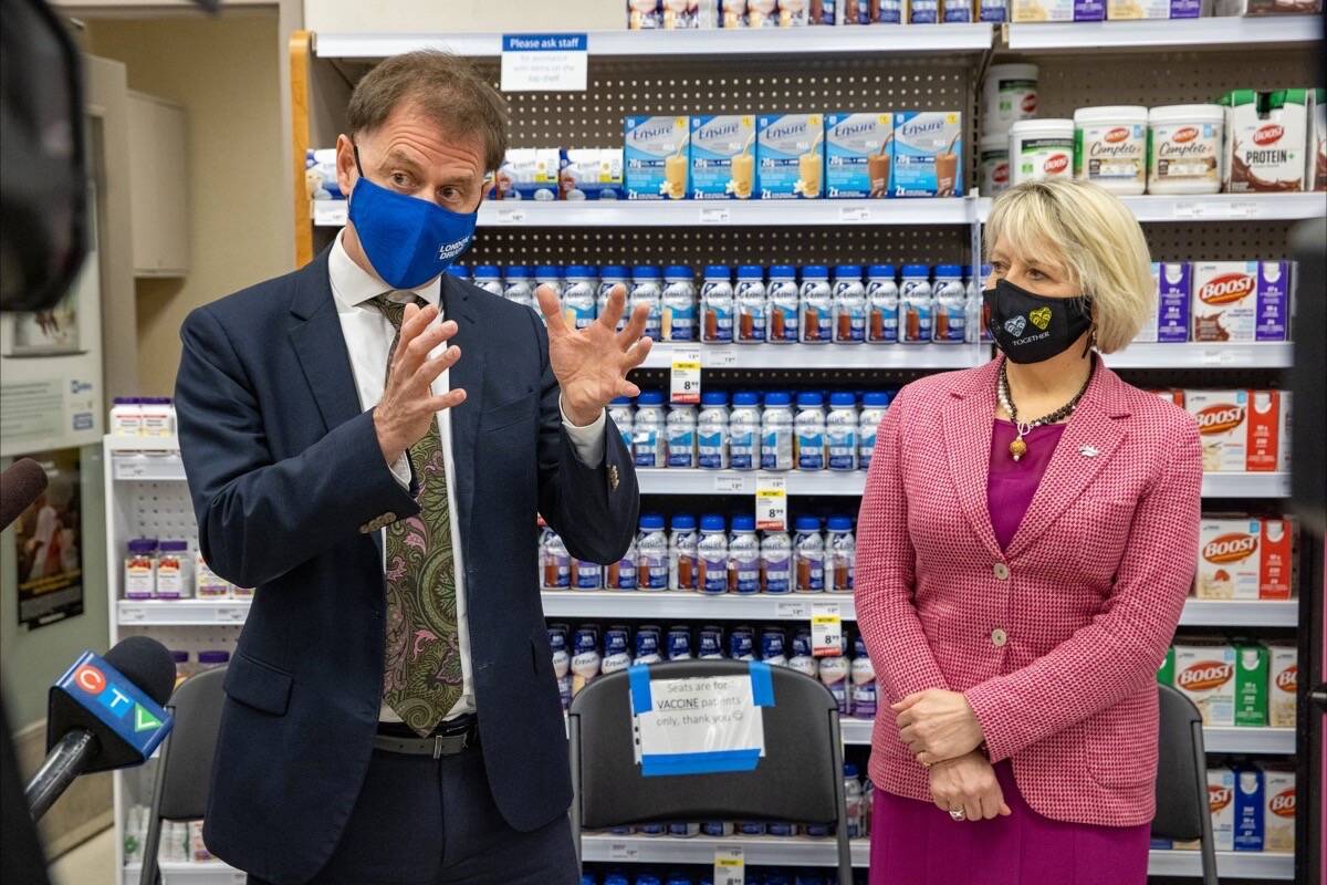 B.C. Health Minister Adrian Dix and provincial health officer Dr. Bonnie Henry announce expansion of COVID-19 booster shots to pharmacies, Victoria, Dec. 14, 2021. (B.C. government photo)