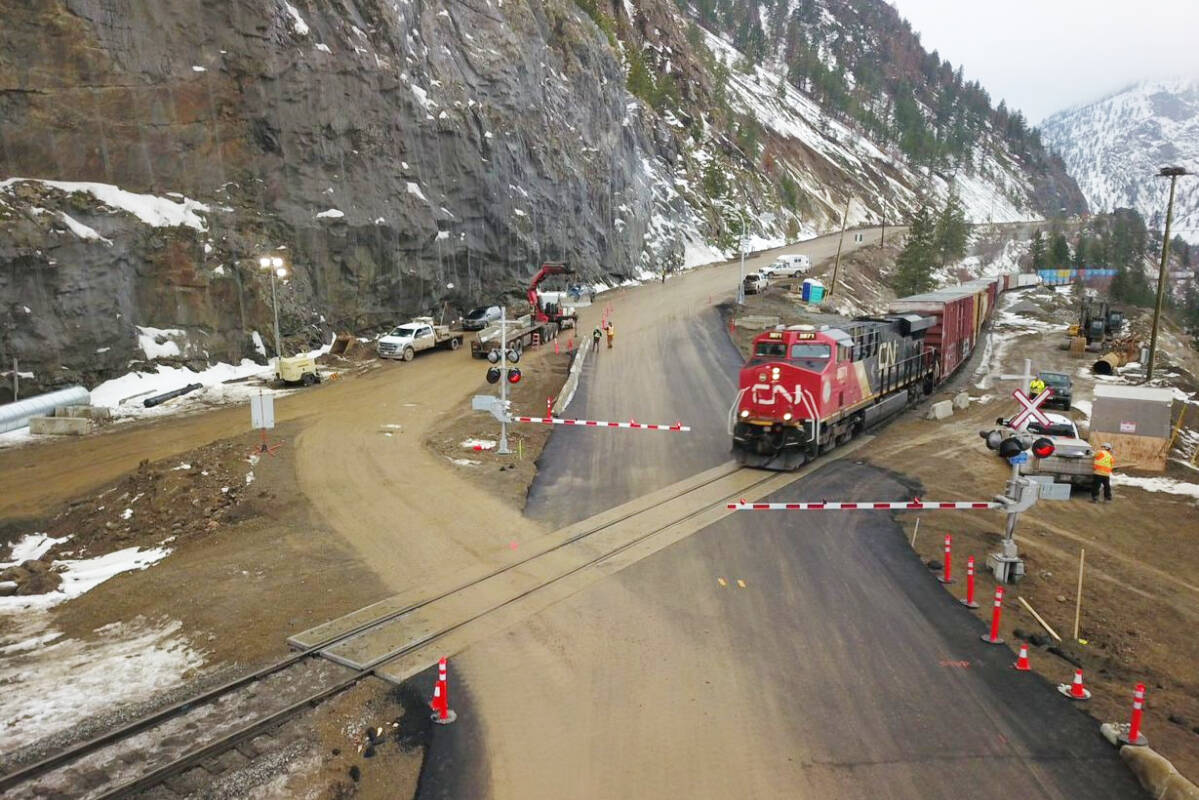 The first train crosses the new controlled, temporary at-grade level crossing of Highway 1 at Tank Hill north of Lytton on Jan. 14. (Photo credit: MOTI)