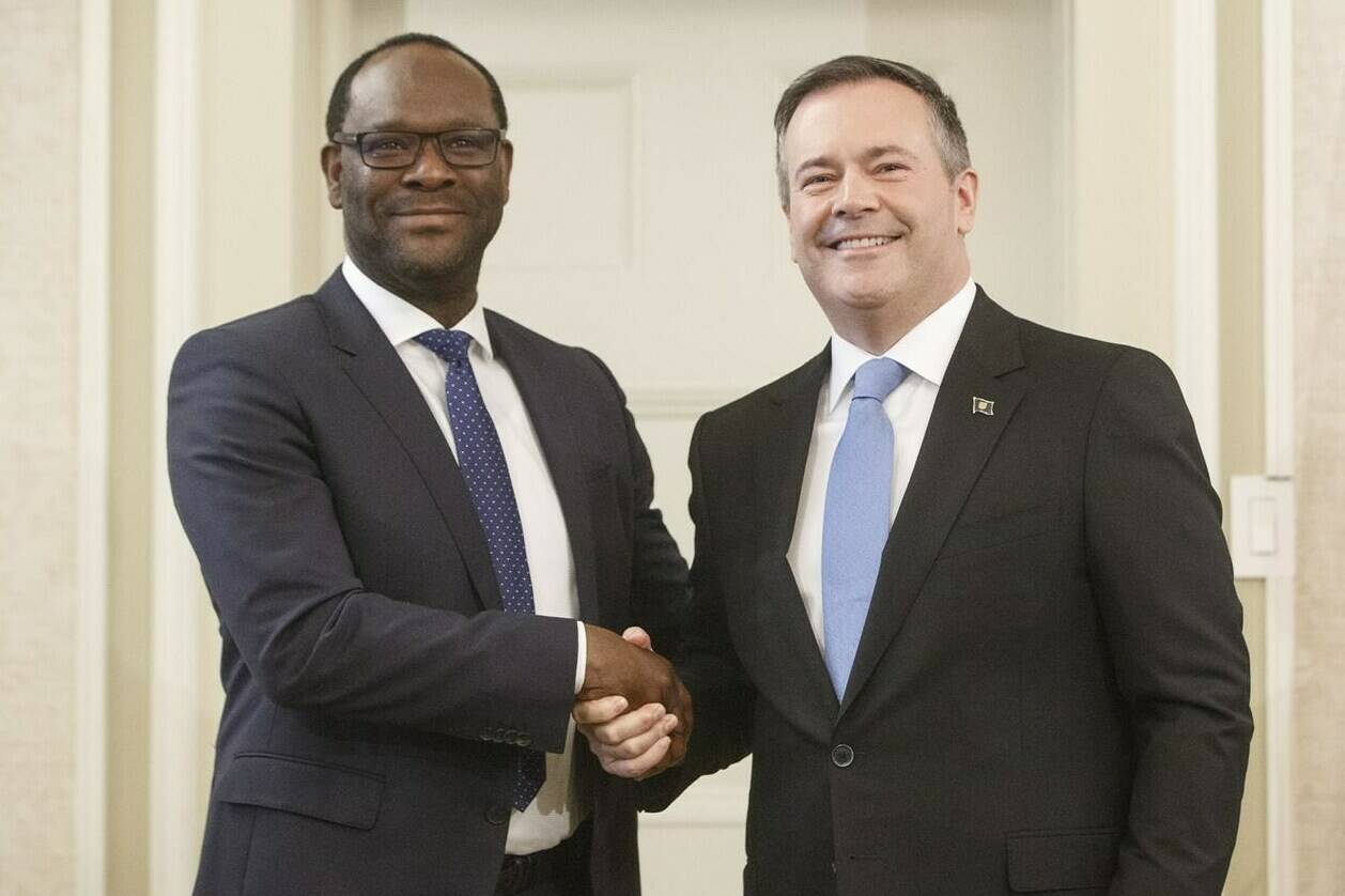 Alberta premier Jason Kenney shakes hands with Kaycee Madu, Minister of Municipal Affairs, after being sworn into office in Edmonton on Tuesday April 30, 2019. Madu, who is currently the province's justice minister, is being called on to resign for phoning Edmonton’s police chief with concerns about a traffic ticket. THE CANADIAN PRESS/Jason Franson