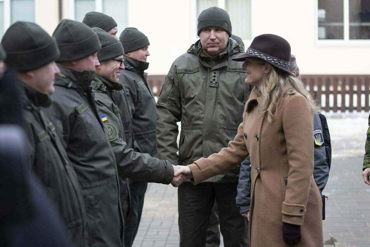 In this photo provided by Ukrainian National Guard Press Office Canada’s Minister of Foreign Affairs Melanie Joly, right, greets Ukrainian soldiers during her visit to the National Guard base close to Kyiv, Ukraine, Tuesday, Jan. 18, 2022. THE CANADIAN PRESS/AP-Ukrainian National Guard Press Office via AP