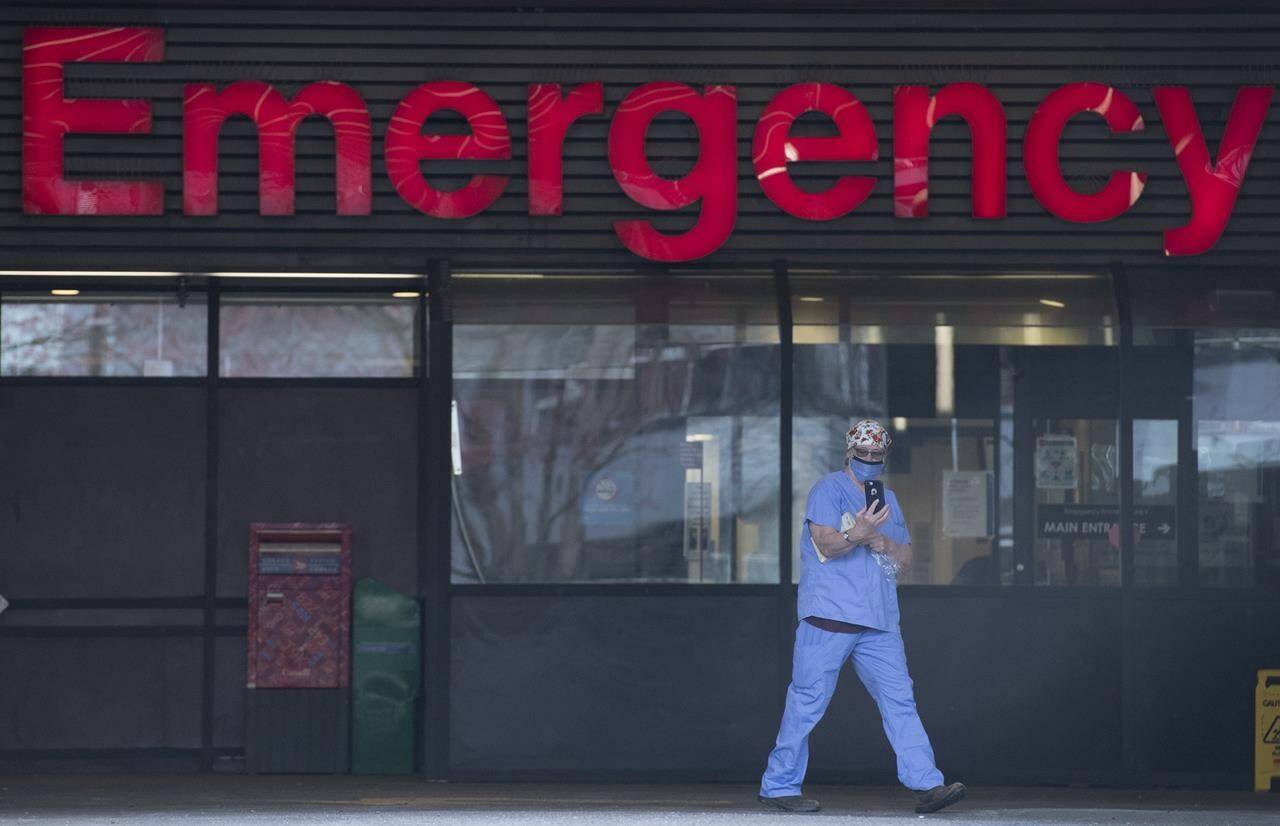 A health care worker is seen outside the Emergency dept. of the Vancouver General Hospital in Vancouver on March 30, 2020. Hospital emergency rooms in Alberta are likely to assess complaints from First Nations people as less urgent than those from other patients even when their problems are the same, says a new study that looked at millions of such visits. THE CANADIAN PRESS/Jonathan Hayward