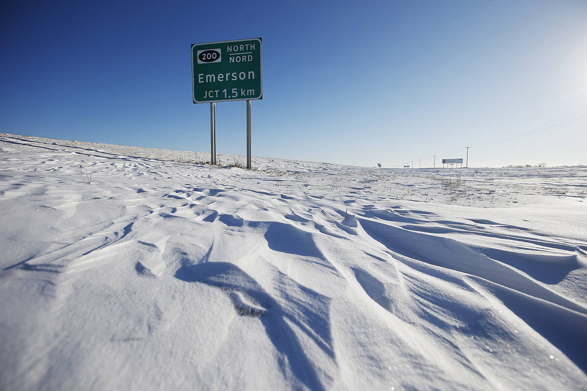 Road signage is photographed just outside of Emerson, Man. on Thursday, January 20, 2022. American investigators believe the deaths of four people, including a baby and a teen, whose bodies were found in Manitoba near the United States border are linked to a larger human smuggling operation. THE CANADIAN PRESS/John Woods