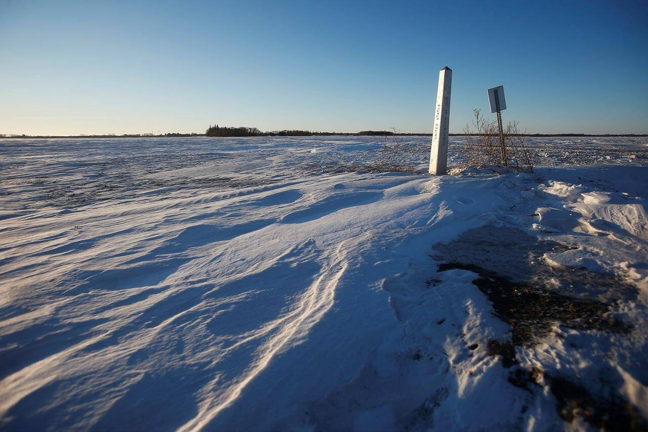A border marker is shown just outside of Emerson, Man. on Thursday, Jan. 20, 2022. A Florida man will appear before a judge in Minnesota on Monday to face human smuggling charges after three people and an infant, believed to be a family from India, were found dead Wednesday just metres from the Canada-U.S. border. THE CANADIAN PRESS/John Woods