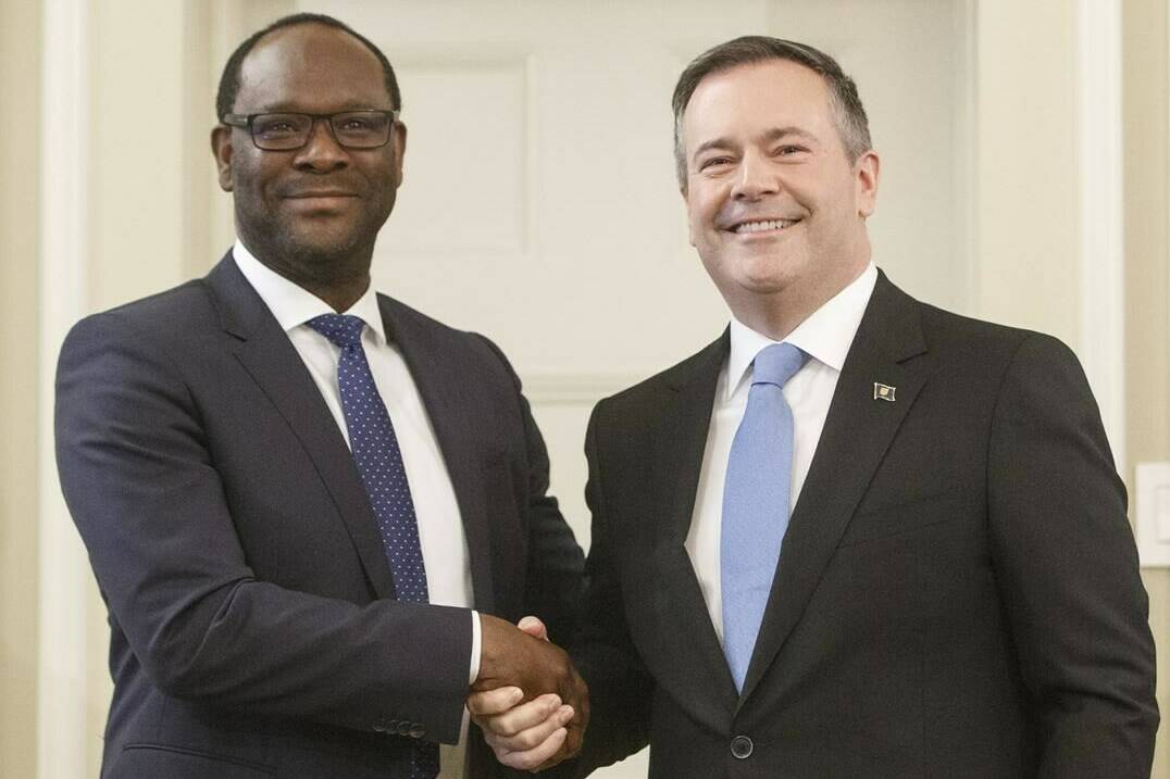 Alberta Premier Jason Kenney shakes hands with Kaycee Madu after he was sworn in as minister of municipal affairs in Edmonton on Tuesday, April 30, 2019. A retired judge from Alberta’s Court of Queen’s Bench is to determine whether Madu, now suspended as justice minister, interfered with the administration of justice. THE CANADIAN PRESS/Jason Franson