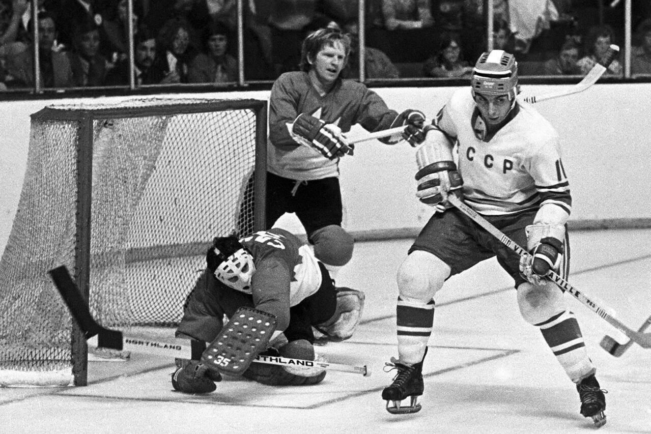 Team Canada goaltender Tony Esposito covers the net behind Team USSR’s Eugeny Zimin as Pat Stapleton looks on during the 1972 Summit Series in Toronto on Sept. 4, 1972. THE CANADIAN PRESS/Peter Bregg