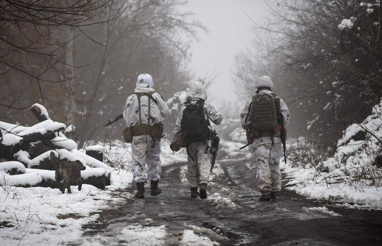 Ukrainian soldiers walks at the line of separation from pro-Russian rebels near Katerinivka, Donetsk region, Ukraine, Tuesday, Dec 7, 2021. THE CANADIAN PRESS/AP - Andriy Dubchak