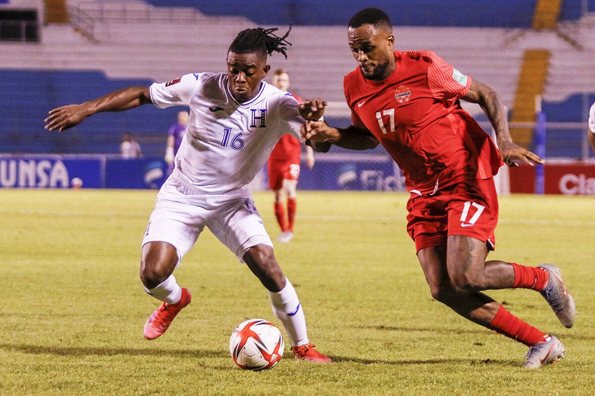 Honduras’ Wisdom Quaye, left, and Canada’s Cyle Larinfight for the ball during a qualifying soccer match for the FIFA World Cup Qatar 2022 in San Pedro Sula, Honduras, Thursday, Jan. 27, 2022. (AP Photo/Delmer Martinez)
