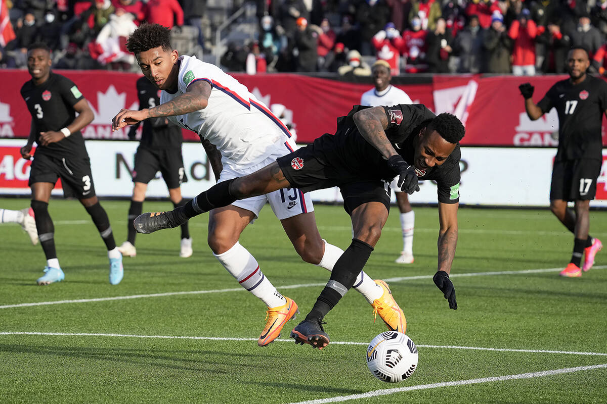 United States’ Chris Richards (15) and Canada’s Mark Anthony Kaye (14) vie for the ball during first half World Cup qualifying soccer action in Hamilton, Ont., Sunday, Jan. 30, 2022. THE CANADIAN PRESS/Frank Gunn