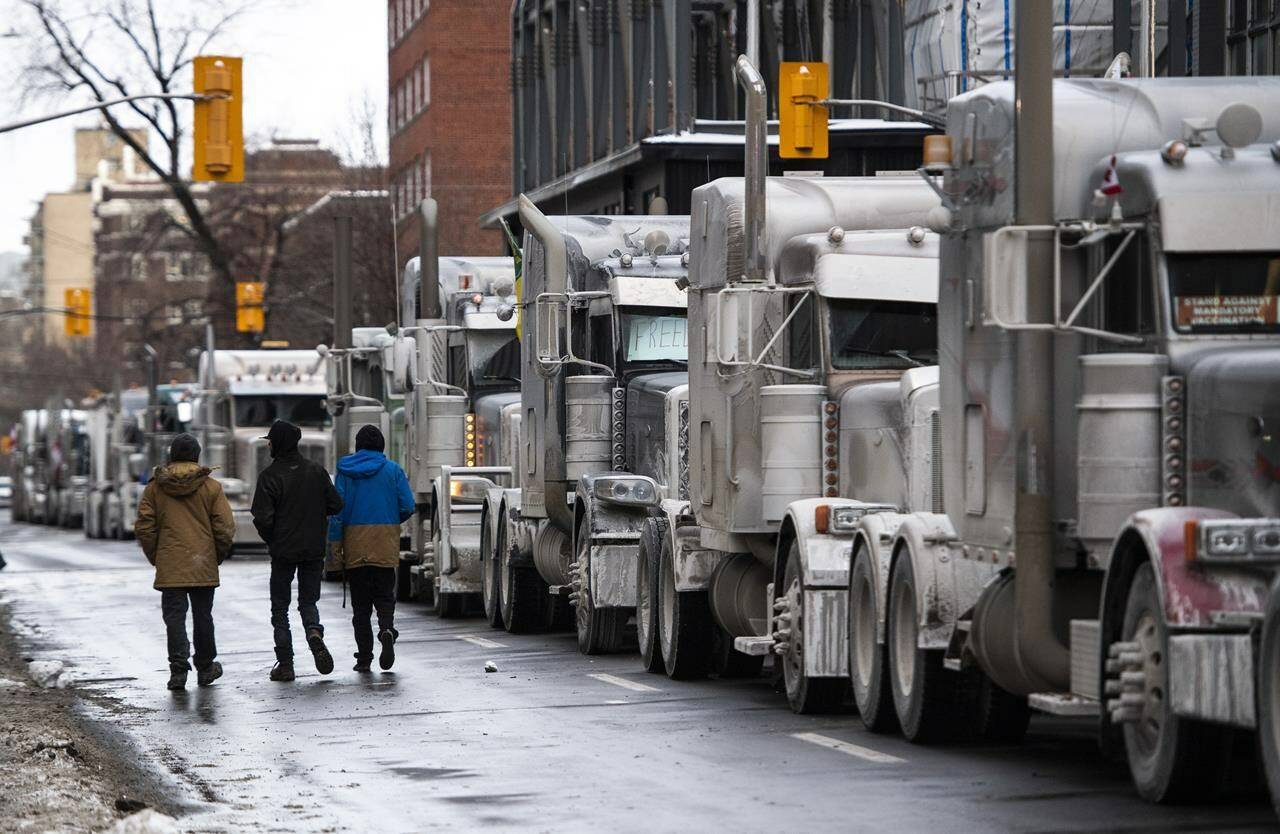 Trucks are parked on Metcalfe Street as a rally against COVID-19 restrictions, which began as a cross-country convoy protesting a federal vaccine mandate for truckers, continues in Ottawa, on Sunday, Jan. 30, 2022. Police haven’t reported any violence at the ongoing Ottawa rally against vaccine mandates and other government-imposed COVID-19 restrictions, but critics warn that conflating the absence of bloodshed with “peaceful” protest downplays the dangers of this weekend’s demonstration. THE CANADIAN PRESS/Justin Tang