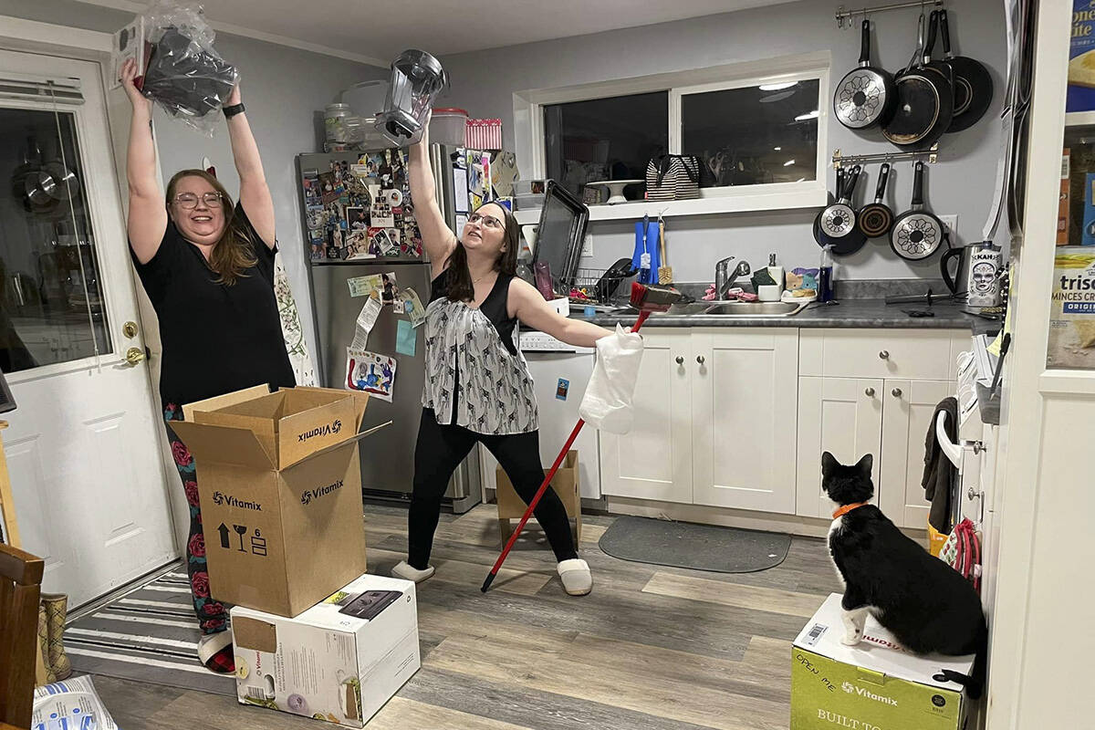 Nikki and Jessica Gerson-Neeves (left to right) hold their blender triumphantly over their heads. (Facebook/Temperamental Chucklefuck and Friends)