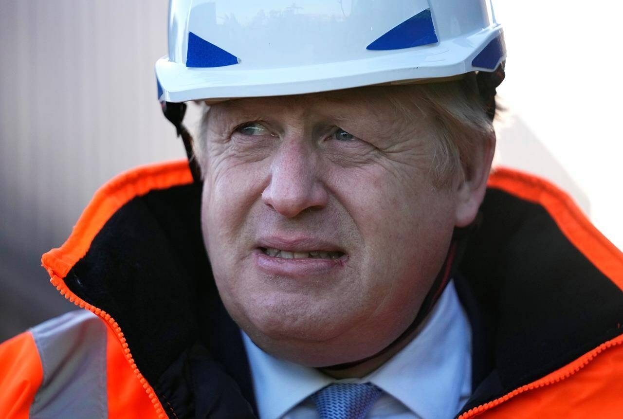 British Prime Minister Boris Johnson visits the Tilbury Docks in Tilbury, England, Monday, Jan. 31, 2022. The port, located on the River Thames, handles a variety of bulk cargo and container traffic is one of Britain’s three major container ports. (AP Photo/Matt Dunham, Pool)