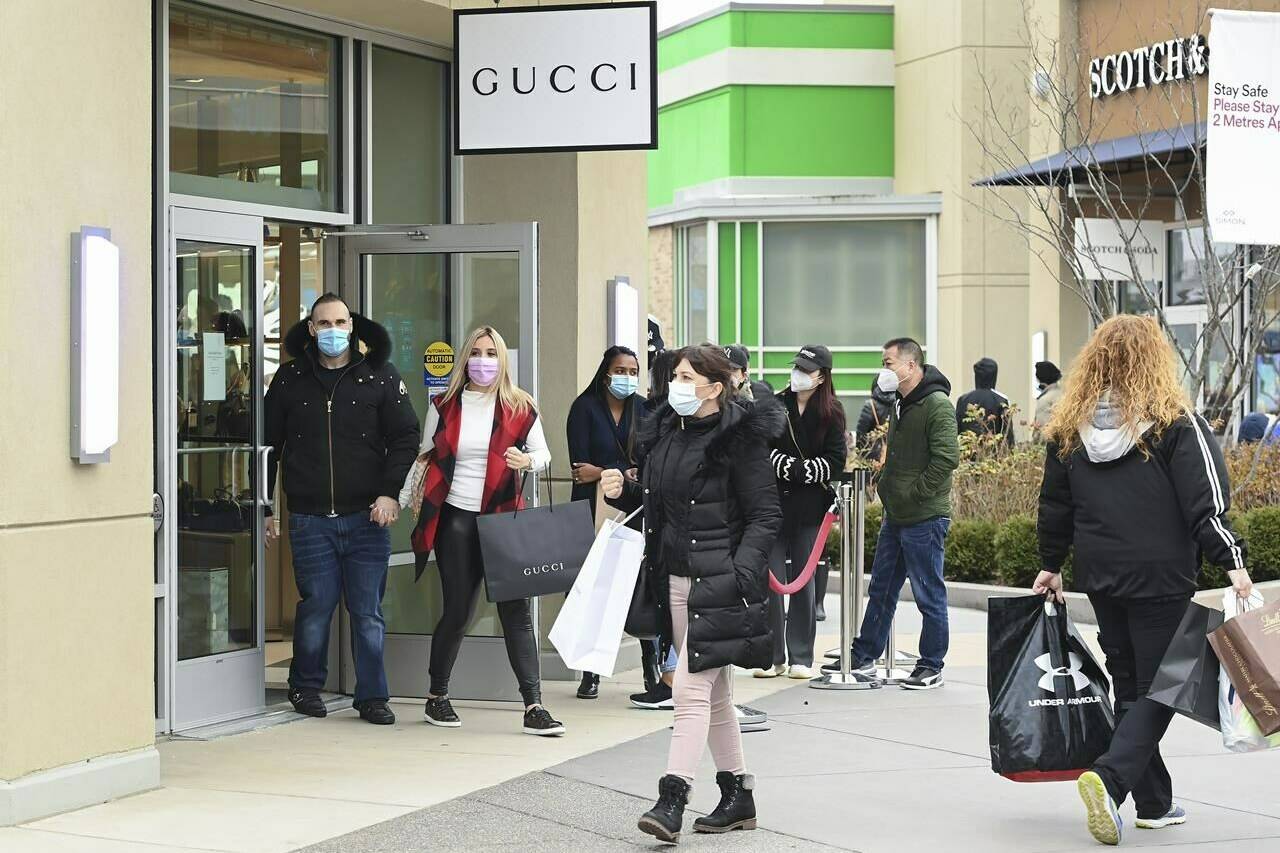 People line up at the Toronto Premium Outlets mall on Black Friday for shopping sales during the COVID-19 pandemic in Milton, Ont., Friday, Nov. 27, 2020. THE CANADIAN PRESS/Nathan Denette