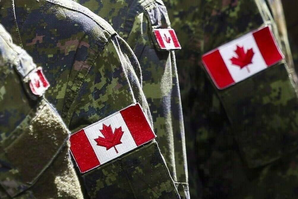 Members of the Canadian Armed Forces march during the Calgary Stampede parade in Calgary on July 8, 2016. The Department of National Defence says dozens of Canadian Armed Forces members who refused to get vaccinated have now been kicked out of the military. THE CANADIAN PRESS/Jeff McIntosh