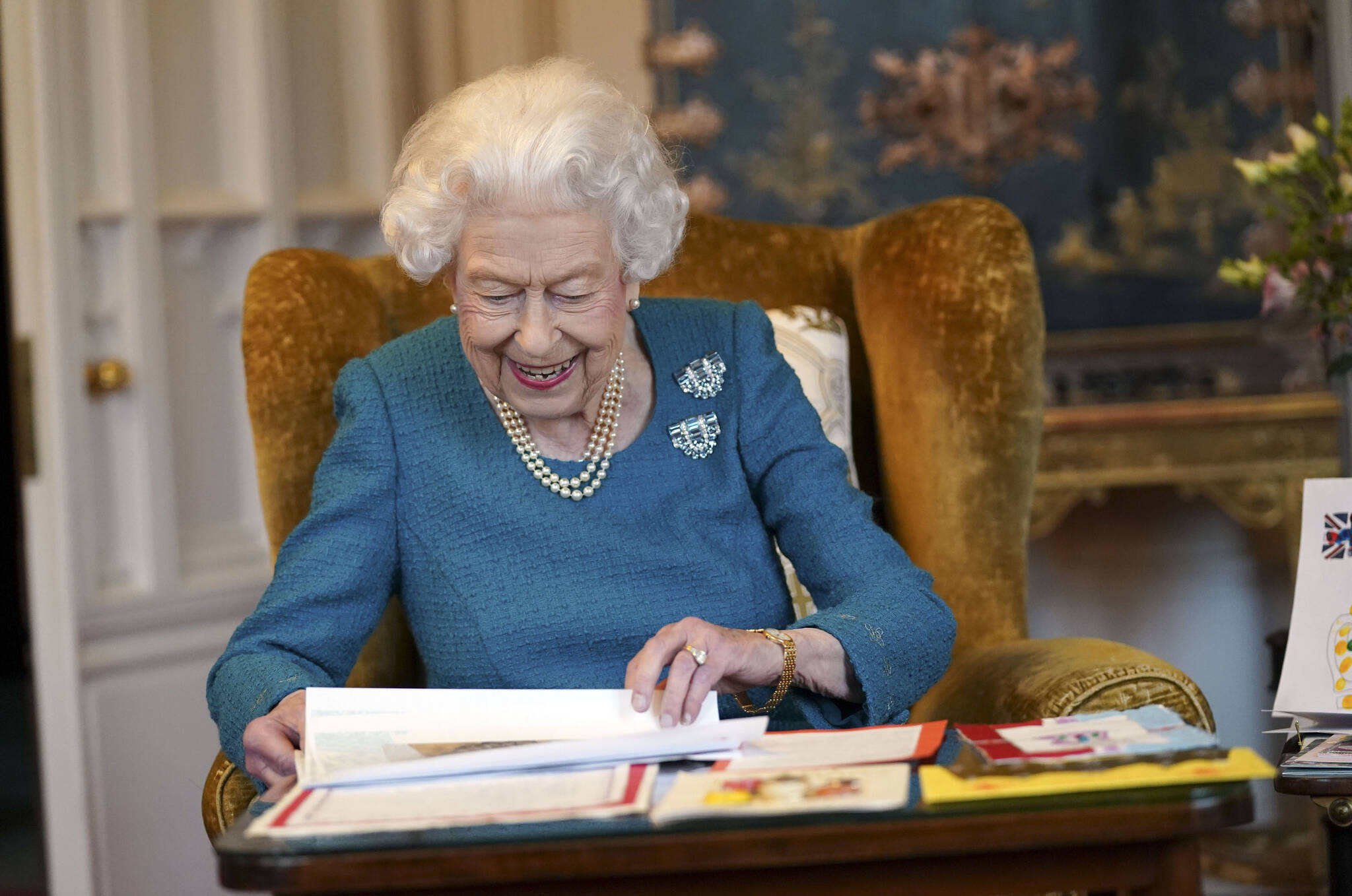 Britain’s Queen Elizabeth II looks at a display of memorabilia from her Golden and Platinum Jubilees in the Oak Room at Windsor Castle, Windsor, England, Friday Feb. 4, 2022. Queen Elizabeth II will mark 70 years on the throne Sunday Feb. 6, an unprecedented reign that has made her a symbol of stability as the United Kingdom navigated an age of uncertainty. (Steve Parsons/Pool via AP)