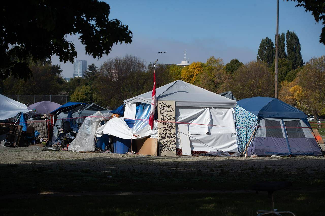 A message is written on a door outside a tent at a homeless encampment at Strathcona Park in Vancouver on Wednesday, October 7, 2020. A new study says the rates of brain injury are endemic among the homeless.THE CANADIAN PRESS/Darryl Dyck
