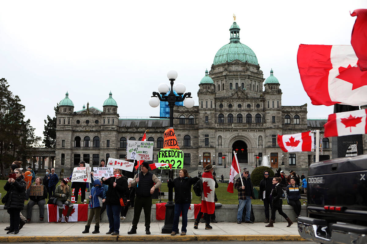 Supporters gather near the legislature to protest during a demonstration against COVID-19 restrictions in Victoria, Saturday, Feb. 5, 2022. THE CANADIAN PRESS/Chad Hipolito