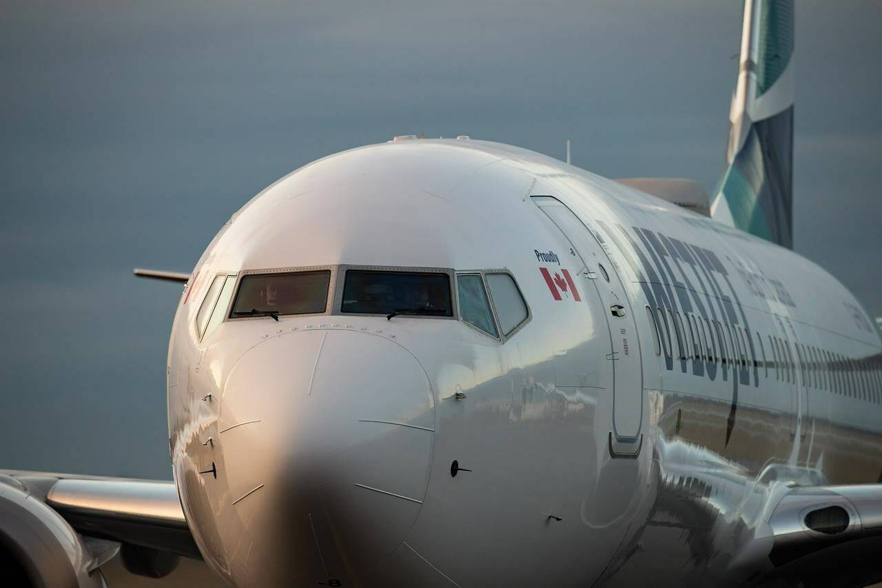 A WestJet Airlines Boeing 737 Max aircraft taxis to a gate after arriving at Vancouver International Airport in Richmond, B.C., on Thursday, January 21, 2021. THE CANADIAN PRESS/Darryl Dyck