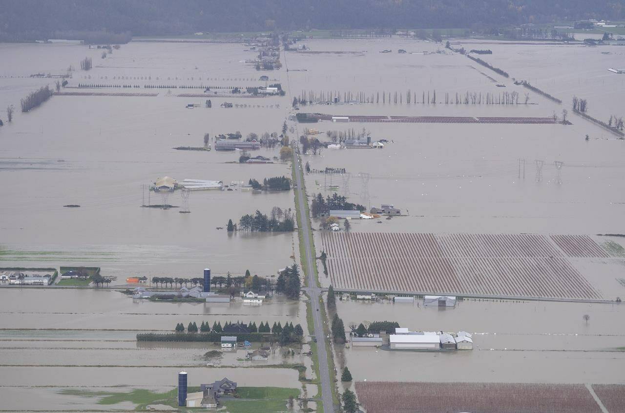 FILE – Flood waters are seen from the air in Abbotsford, B.C., on November 23, 2021. THE CANADIAN PRESS/Jonathan Hayward