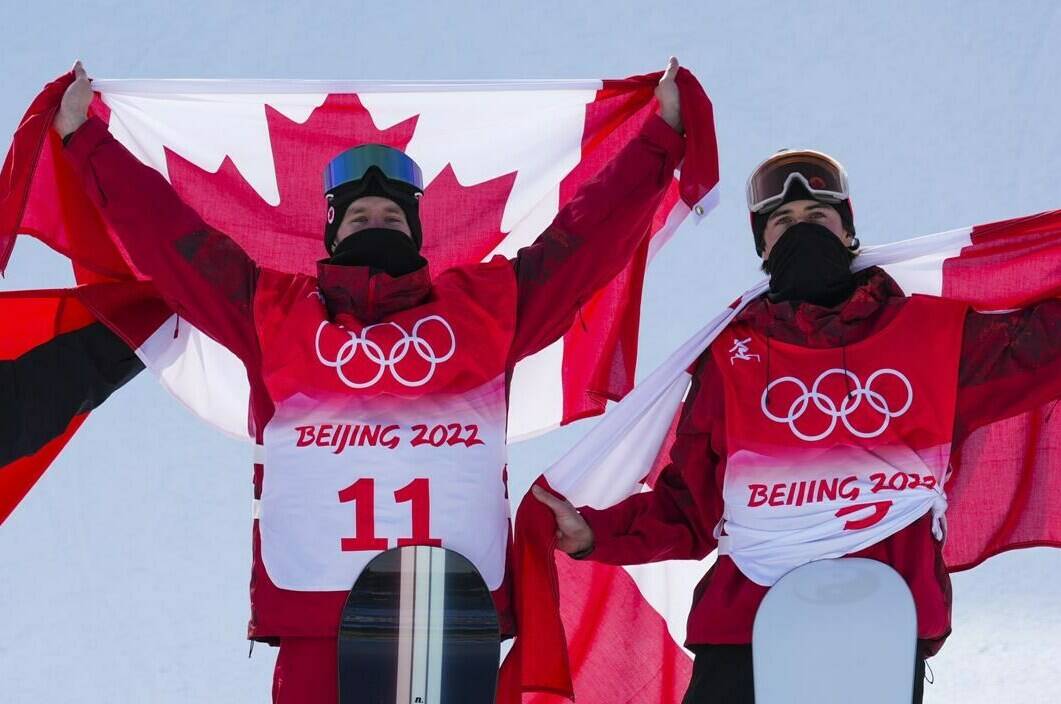 Canada's Max Parrot, of Bromont, Que., left, celebrates his gold medal with bronze medalist and teammate Mark McMorris, of Regina, following the men's slopestyle final at the Beijing Winter Olympic Games, in Zhangjiakou, China, Monday, Feb. 7, 2022. THE CANADIAN PRESS/Sean Kilpatrick