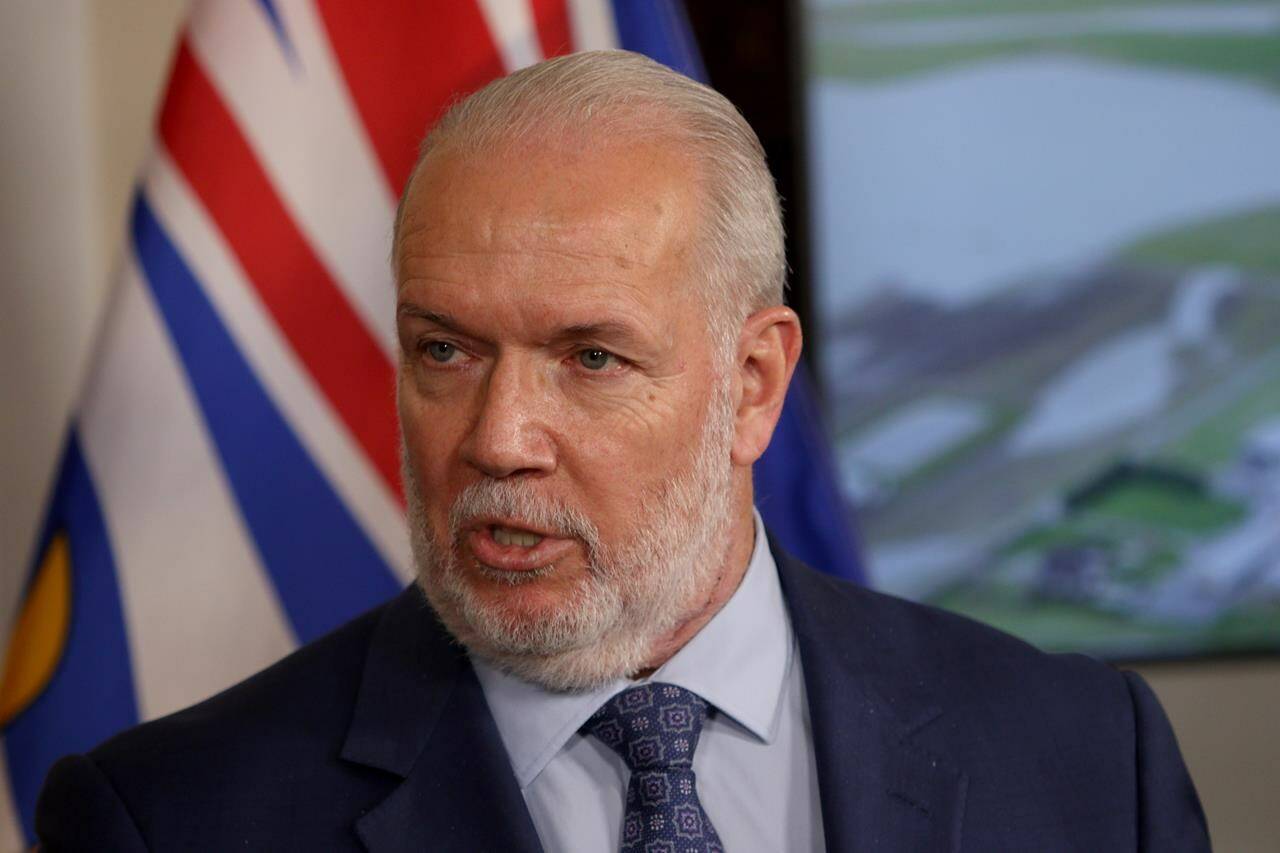 Premier John Horgan talks to media about the recent flooding in the province at the legislature during a press conference in Victoria, Friday, Nov. 26, 2021. Politicians are back at the British Columbia legislature today where the New Democrat government will deliver a throne speech outlining its political agenda for the coming months. THE CANADIAN PRESS/Chad Hipolito