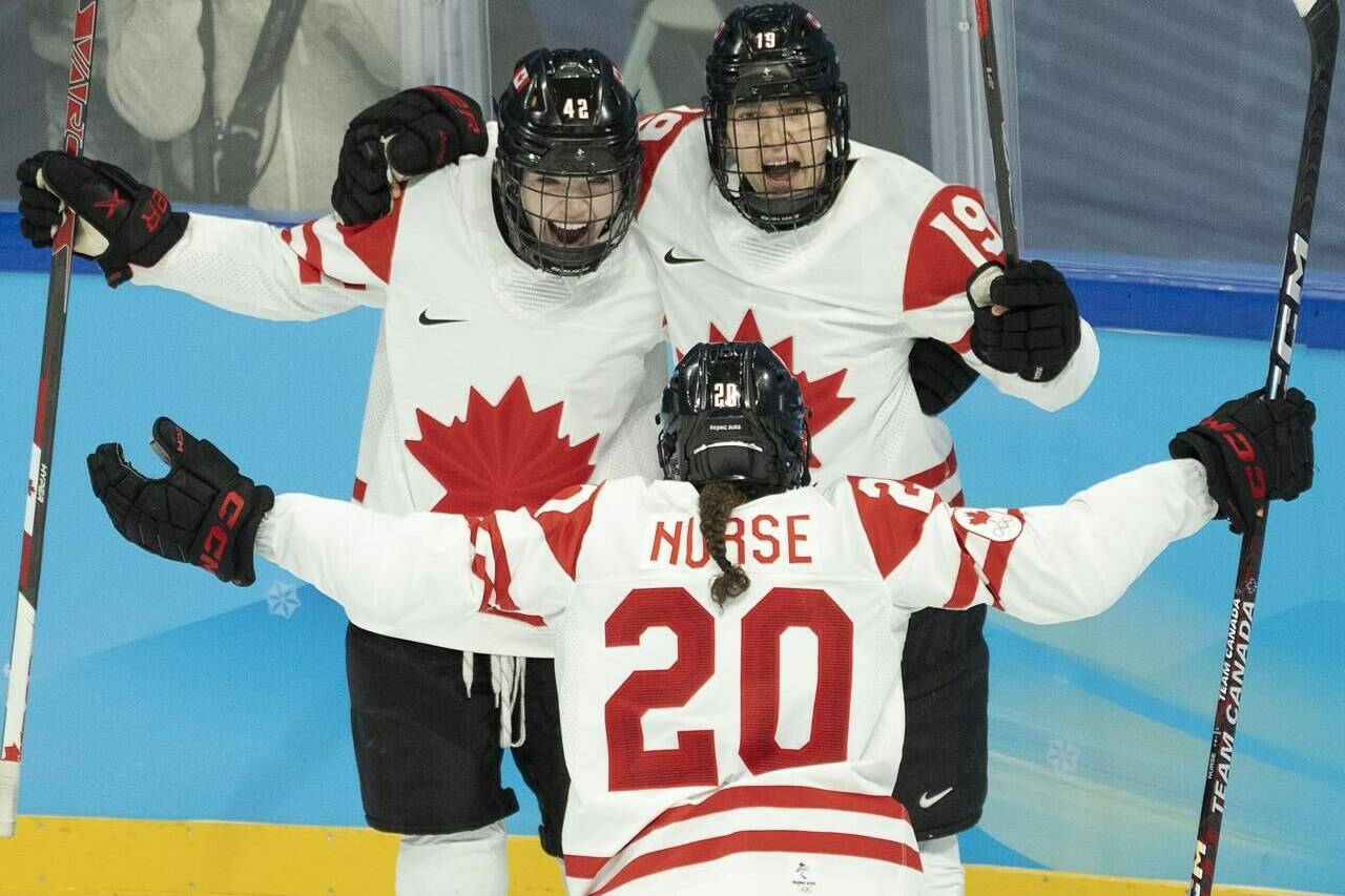 Canada forward Brianne Jenner (19) celebrates with teammates Claire Thompson (42) and Sarah Nurse (20) after scoring her second goal during second period women’s ice hockey action against the United States at the 2022 Olympic Winter Games, in Beijing, Tuesday, Feb. 8, 2022. Brianne Jenner scored twice and captain Marie-Philip Poulin scored on a penalty shot for Canada in a 4-2 win over the United States in Olympic women’s hockey Tuesday. THE CANADIAN PRESS/Ryan Remiorz