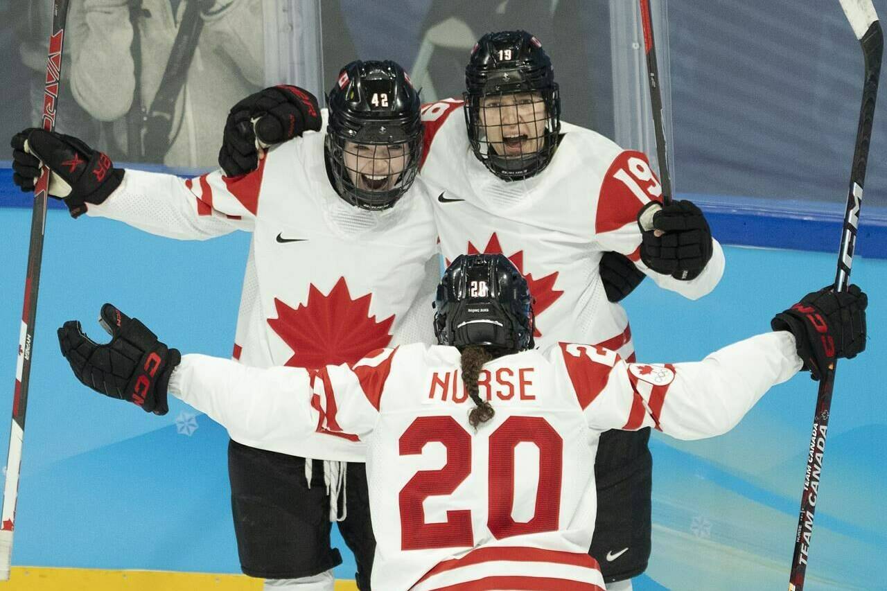 Canada forward Brianne Jenner (19) celebrates with teammates Claire Thompson (42) and Sarah Nurse (20) after scoring her second goal during second period women’s ice hockey action against the United States at the 2022 Olympic Winter Games, in Beijing, Tuesday, Feb. 8, 2022. Brianne Jenner scored twice and captain Marie-Philip Poulin scored on a penalty shot for Canada in a 4-2 win over the United States in Olympic women’s hockey. THE CANADIAN PRESS/Ryan Remiorz