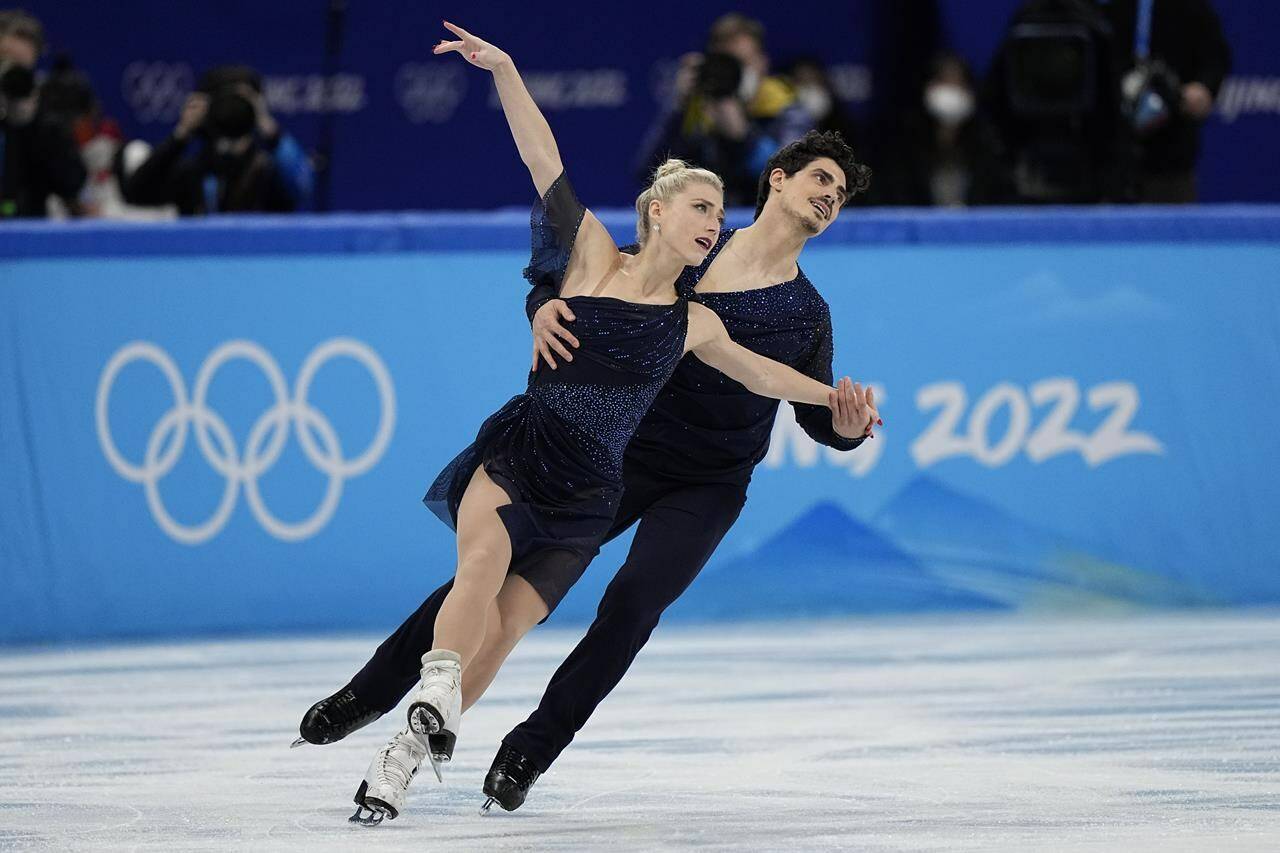 Piper Gilles and Paul Poirier, of Canada, compete in the team ice dance program during the figure skating competition at the 2022 Winter Olympics, Monday, Feb. 7, 2022, in Beijing. (AP Photo/David J. Phillip)