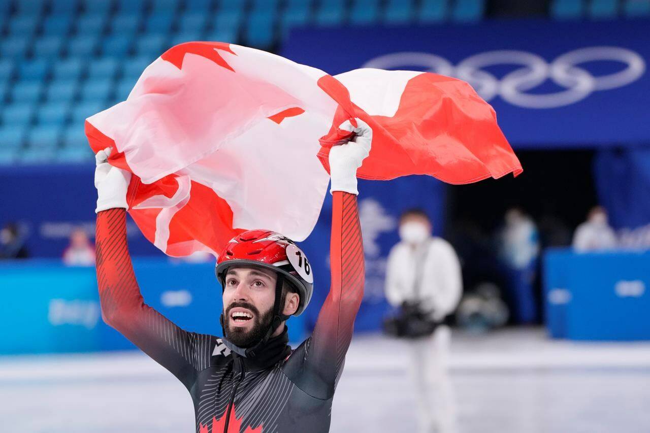 Canada's Steven Dubois celebrates after winning the silver medal in the men's 1,500-metre short-track speedskating event at the Beijing Winter Olympics in Beijing, China, on Wednesday, Feb. 9, 2022. THE CANADIAN PRESS/Paul Chiasson