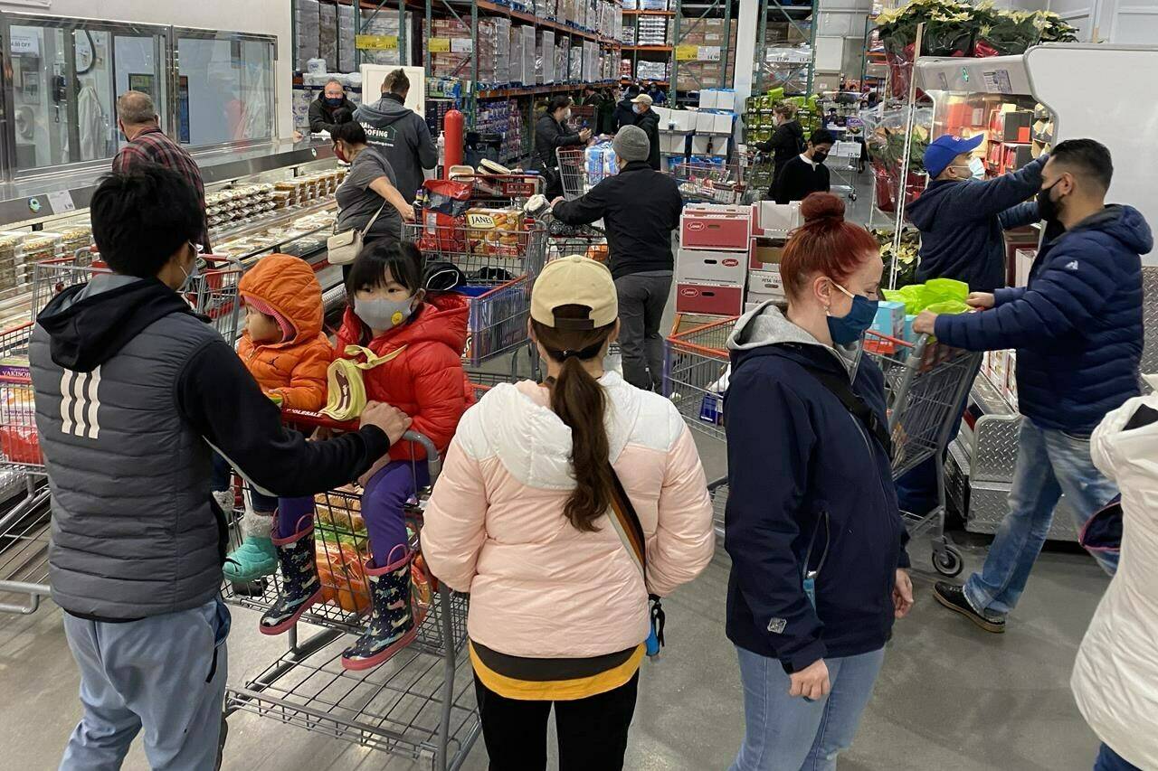 Masked shoppers crowd the aisles at a store in Burnaby, B.C, Sunday, December, 13, 2020. One in 10 Canadians now call smaller urban centres home, according to the 2021 Census from Statistics Canada.THE CANADIAN PRESS/Jonathan Hayward