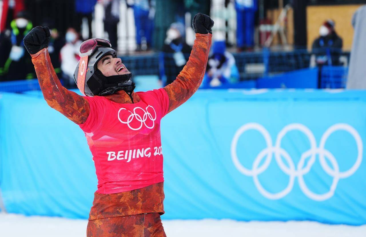 Canada’s Eliot Grondin celebrates his silver medal in the men’s snowboard cross final at the 2022 Beijing Winter Olympics in Zhangjiakou, China on Thursday, February 10, 2022. THE CANADIAN PRESS/Sean Kilpatrick