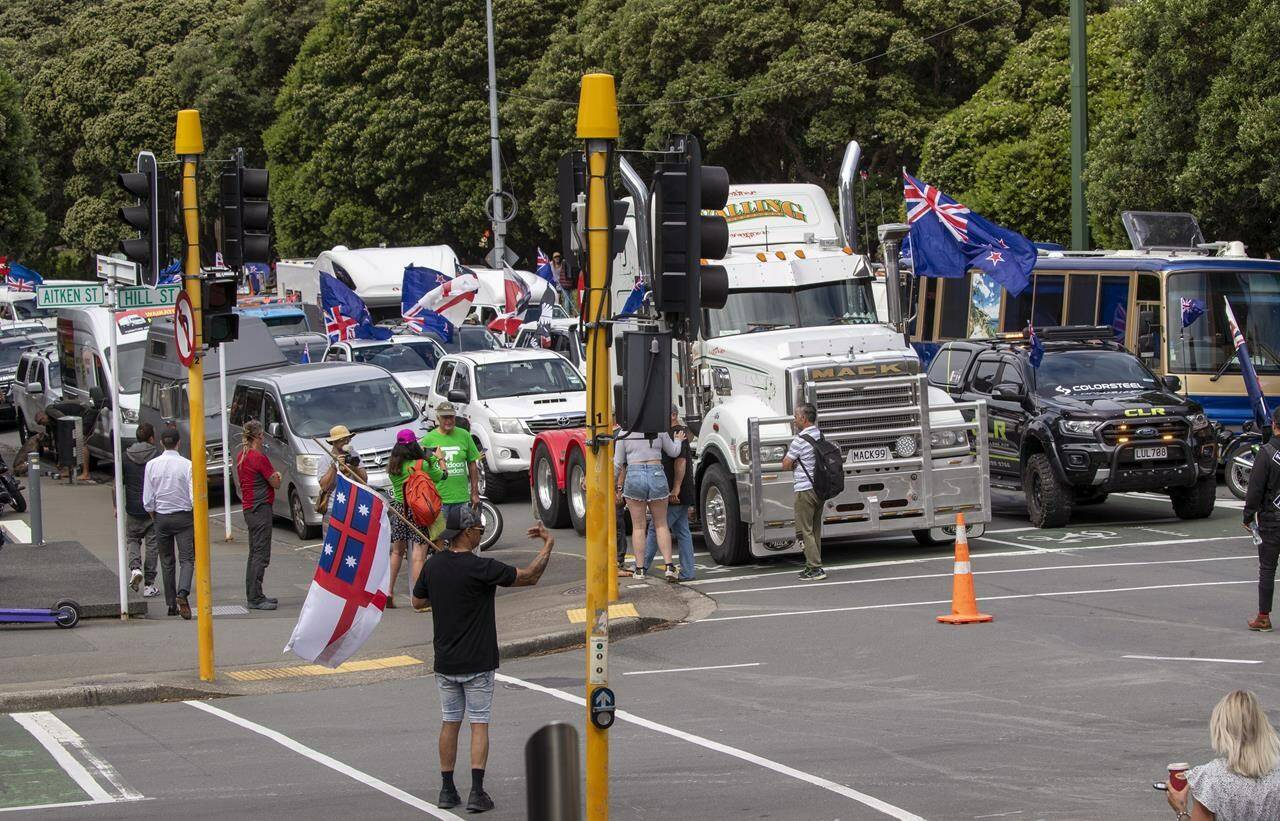 FILE - A convoy of vehicles block an intersection near New Zealand’s Parliament in Wellington on Feb. 8, 2022. Some countries might send in a riot squad to disperse trespassing protesters. In New Zealand, authorities turned on the sprinklers and Barry Manilow. But the moves to try and flush out several hundred protesters who have been camped on Parliament’s grassy grounds since Tuesday had little effect. (Mark Mitchell/New Zealand Herald via AP, File)